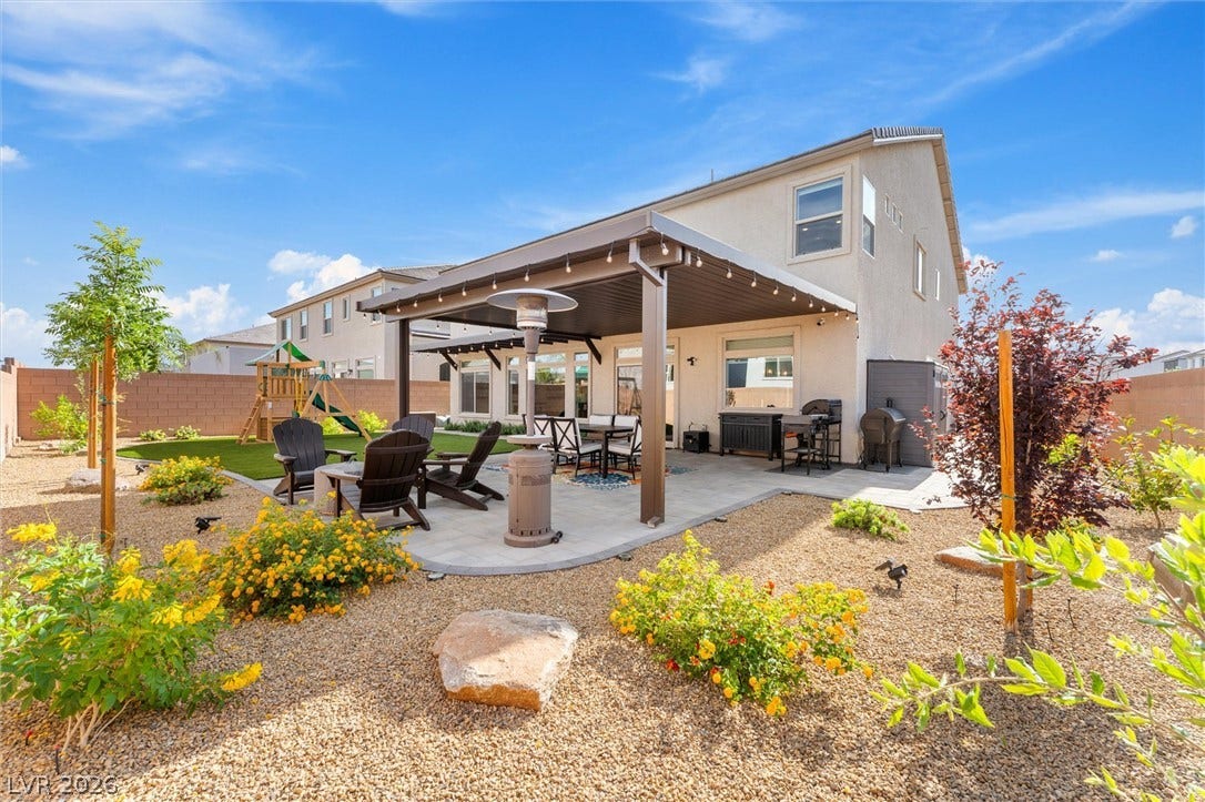 8724 Fortplaid Street, Las Vegas, NV 89139 A spacious covered patio anchors this landscaped backyard featuring low-maintenance desert plantings.