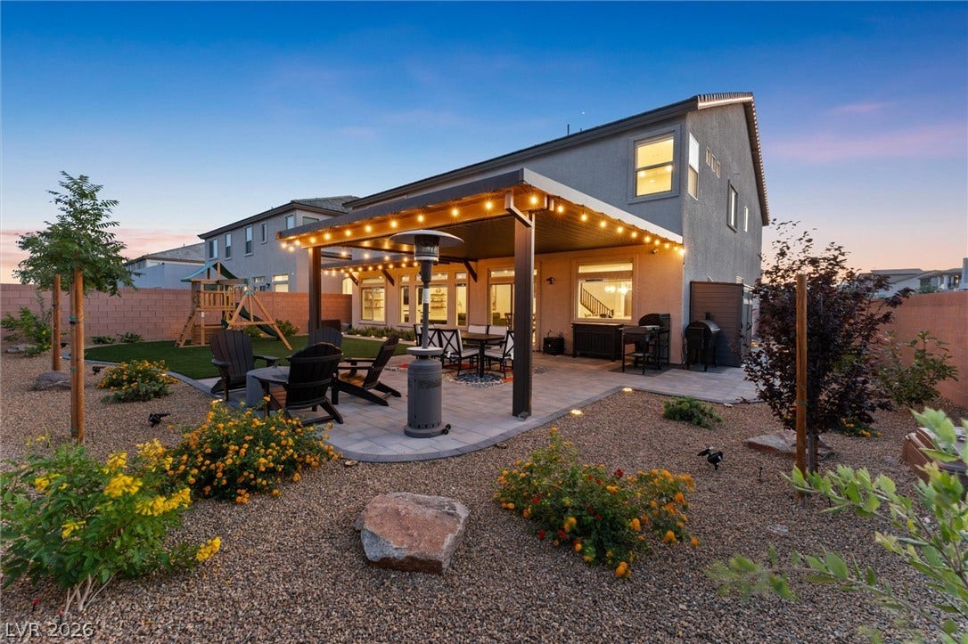 8724 Fortplaid Street, Las Vegas, NV 89139 A spacious covered patio anchors this landscaped backyard, ideal for outdoor gatherings and relaxation.