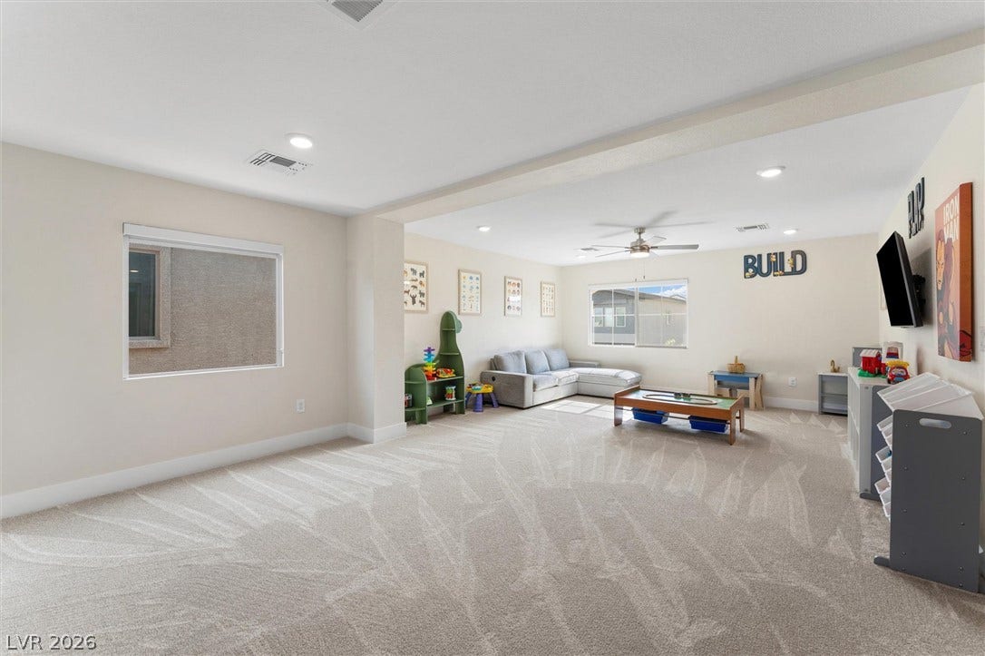 8724 Fortplaid Street, Las Vegas, NV 89139 A spacious carpeted recreation room offers recessed lighting and large windows.