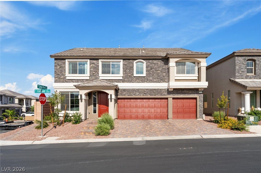 8724 Fortplaid Street, Las Vegas, NV 89139 An inviting exterior balances textured stone accents with a spacious brick-paved driveway.