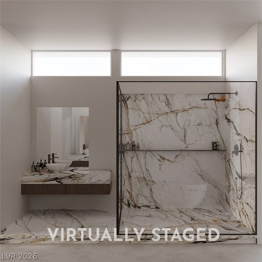 410 Net Zero Drive, Henderson, NV 89012 High clerestory windows illuminate a modern bathroom showcasing rich marble tilework and a floating vanity.