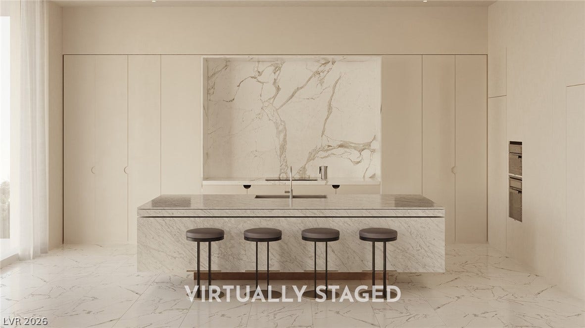 410 Net Zero Drive, Henderson, NV 89012 Minimalist cabinetry pairs with a stone-clad central island in this sleek modern kitchen.