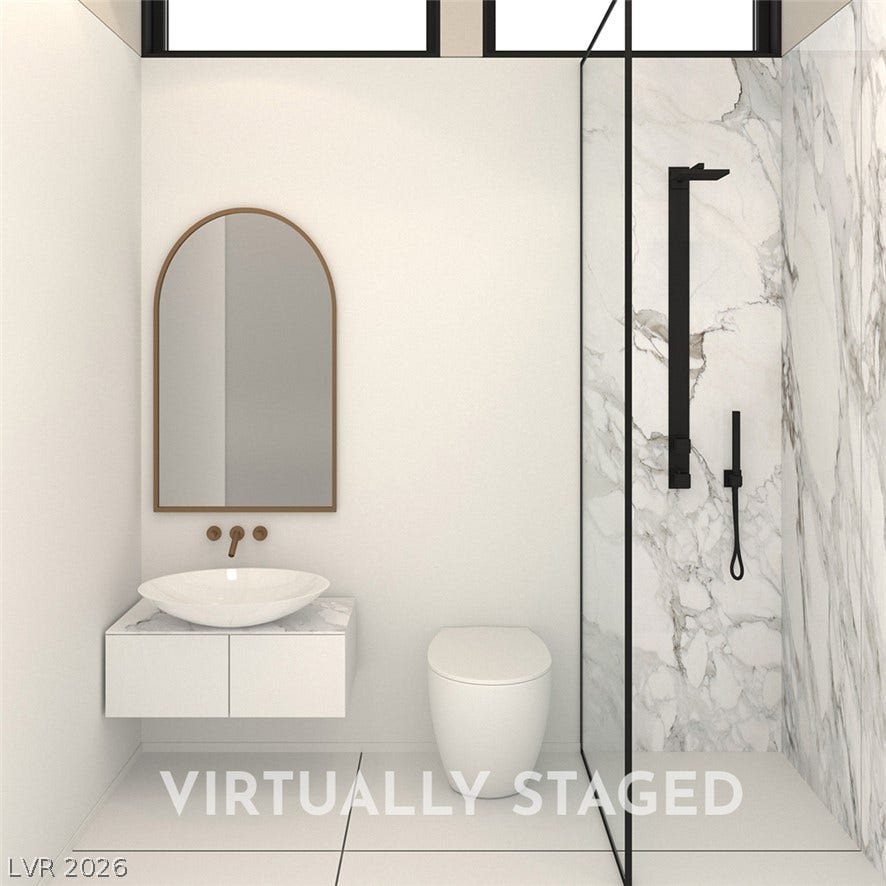 410 Net Zero Drive, Henderson, NV 89012 Minimalist design and elegant marble tiling define this modern bathroom space.