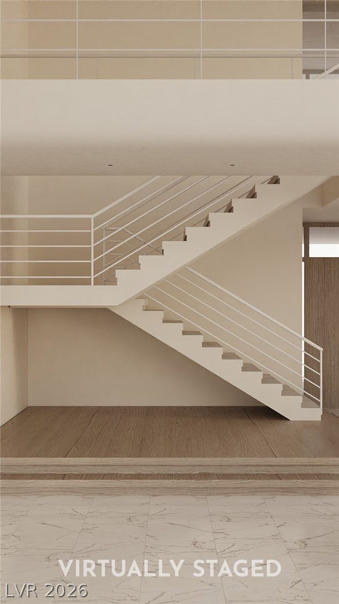 410 Net Zero Drive, Henderson, NV 89012 Striking architectural stairs rise above polished tile and warm wood flooring.