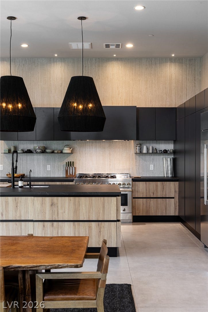 5216 Fading Sunset Drive, Las Vegas, NV 89135 Culinary delights await in this modern kitchen with statement pendant lighting and abundant cabinetry.