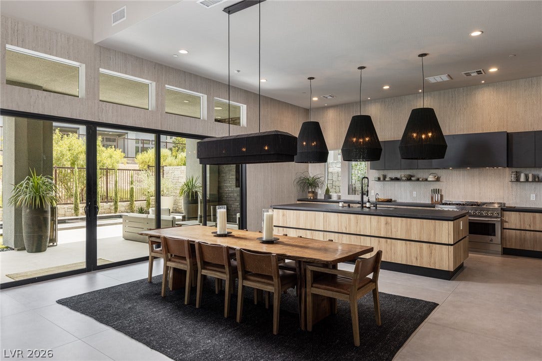 5216 Fading Sunset Drive, Las Vegas, NV 89135 An open-concept living space integrates a dining area and kitchen with seamless access to the outdoors through sliding glass doors.