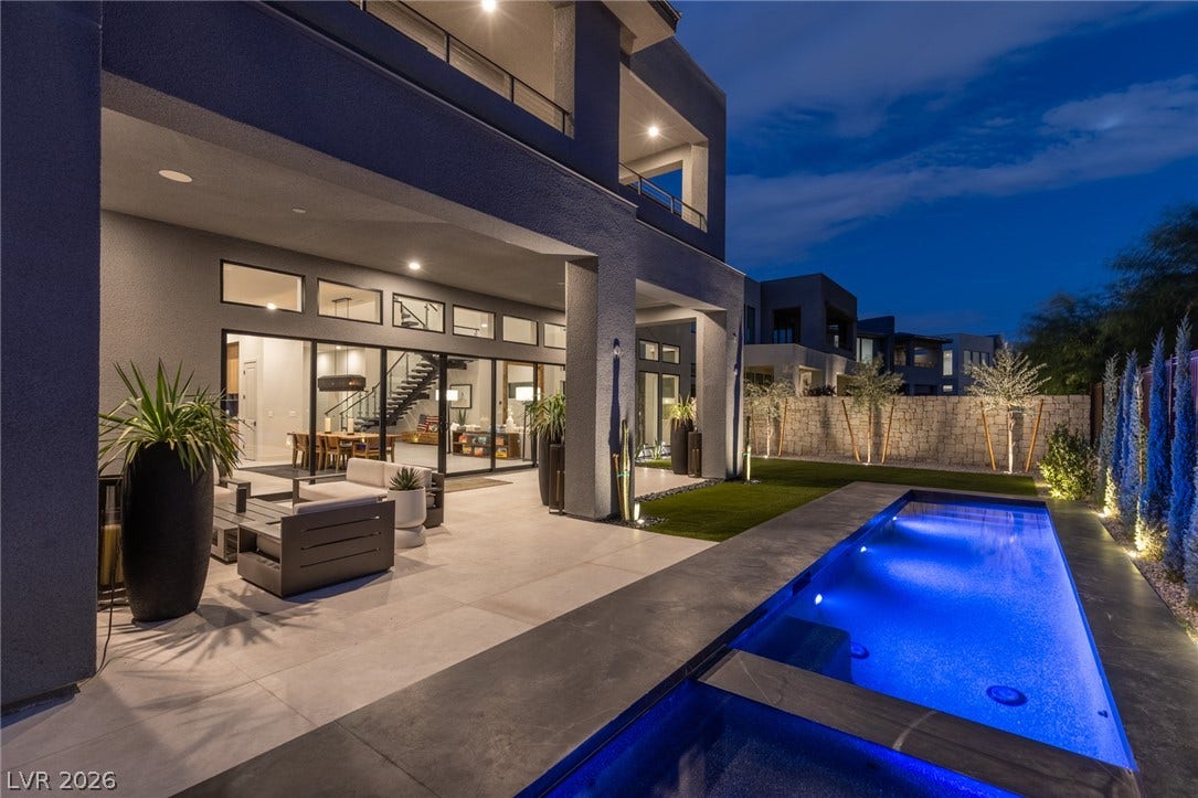5216 Fading Sunset Drive, Las Vegas, NV 89135 A private backyard oasis with an illuminated pool and a generous patio perfect for entertaining under the stars.