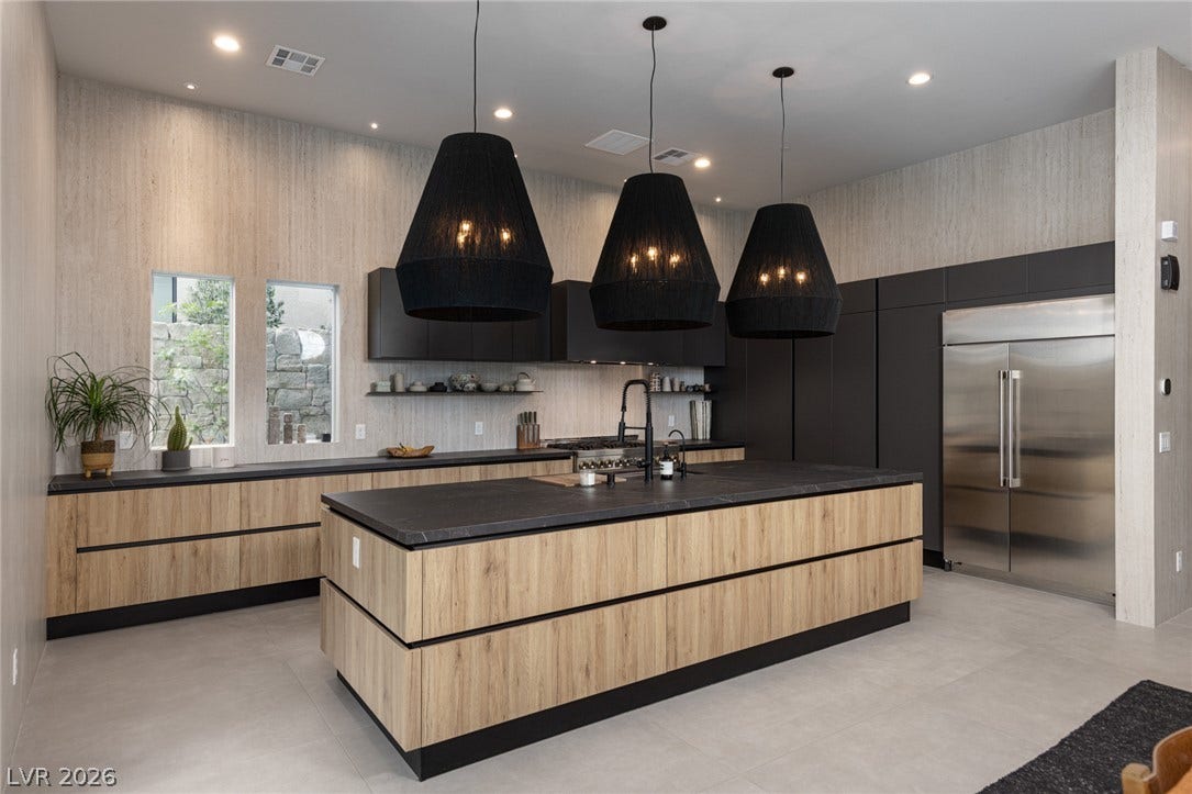 5216 Fading Sunset Drive, Las Vegas, NV 89135 Modern kitchen with sleek cabinetry, a large island, and contemporary lighting fixtures for an inviting culinary space.