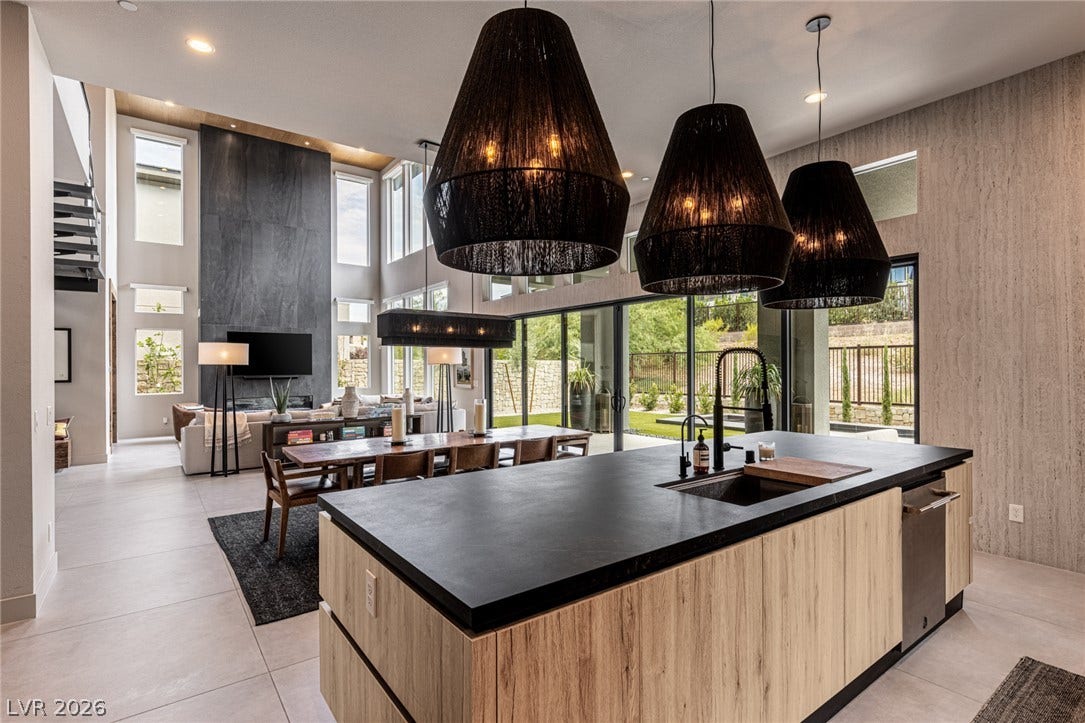 5216 Fading Sunset Drive, Las Vegas, NV 89135 An open-concept living area with a large kitchen island overlooks a vibrant green backyard.