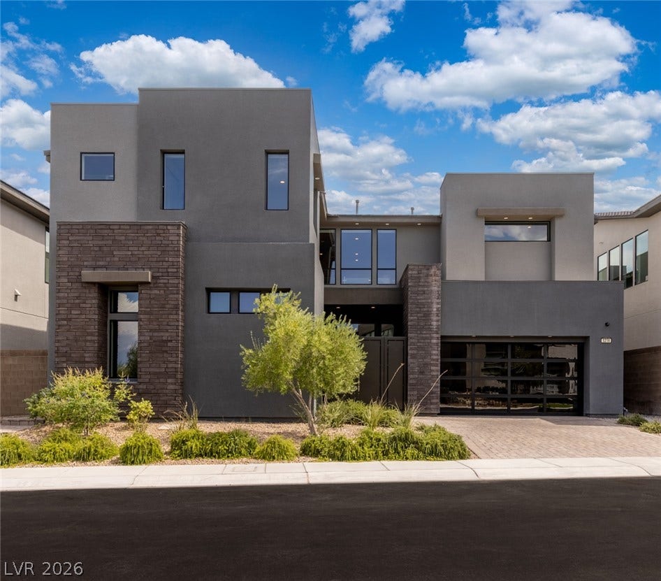 5216 Fading Sunset Drive, Las Vegas, NV 89135 Striking contemporary design showcases bold geometric lines, rich stone accents, and expansive windows.