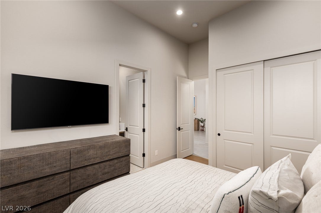 5216 Fading Sunset Drive, Las Vegas, NV 89135 Well-lit sleeping quarters with a high ceiling, recessed lighting, and ample closet space.