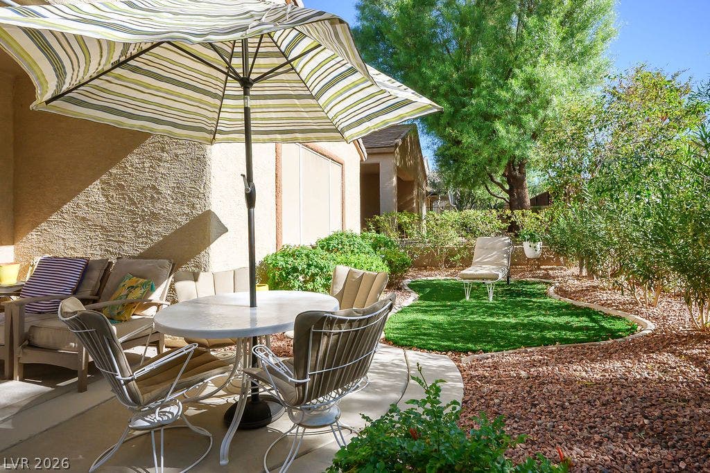 Lush landscaping and a curved green lawn create a private outdoor retreat.