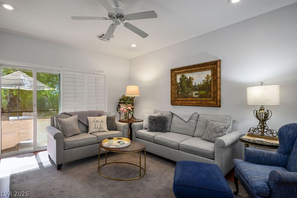 Sliding glass doors with plantation shutters open to the outdoor patio.