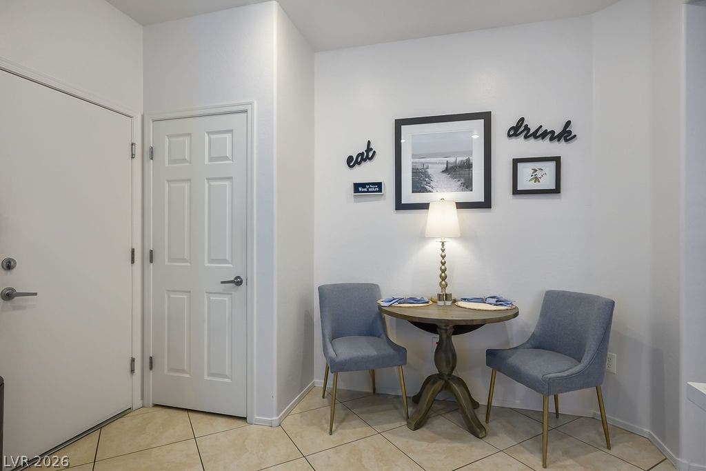 A welcoming entryway transitions smoothly into a functional dining nook with tiled flooring.