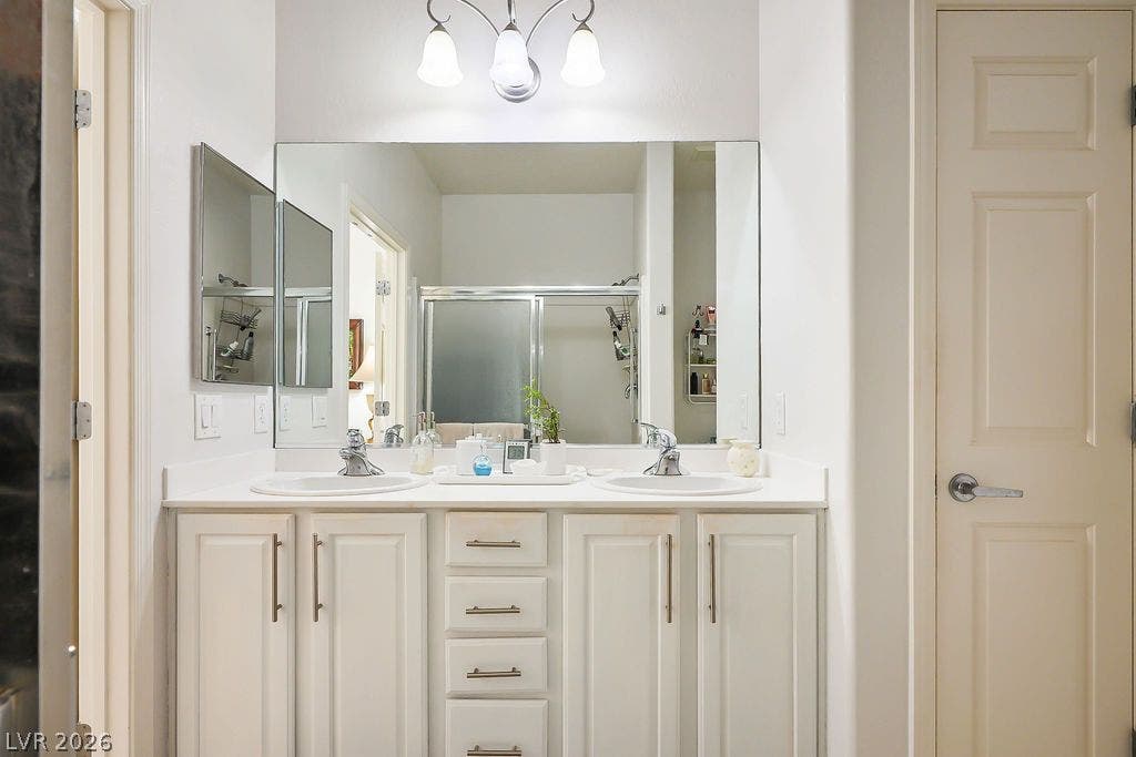 A spacious double vanity provides abundant storage and under-sink cabinetry.