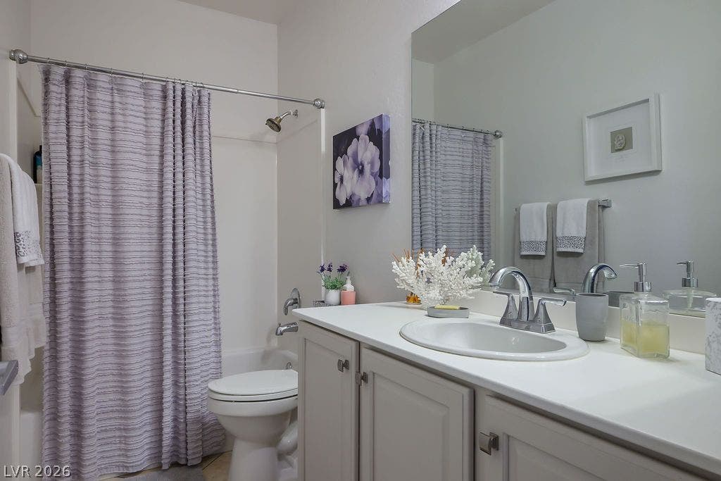 A spacious vanity mirror reflects the clean lines of this modern bath.
