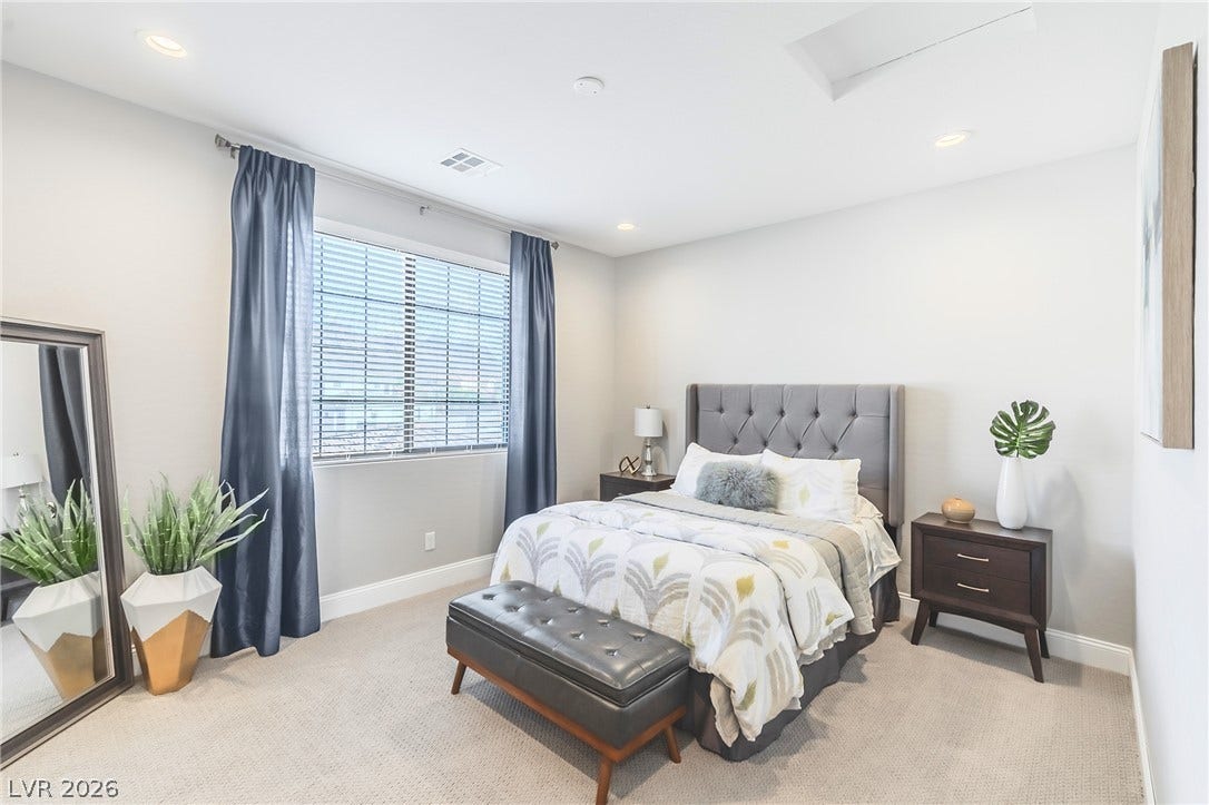 240 San Salvador Avenue, Henderson, NV 89002 Recessed lighting, soft neutral carpeting, and a wide window define this restful bedroom space.