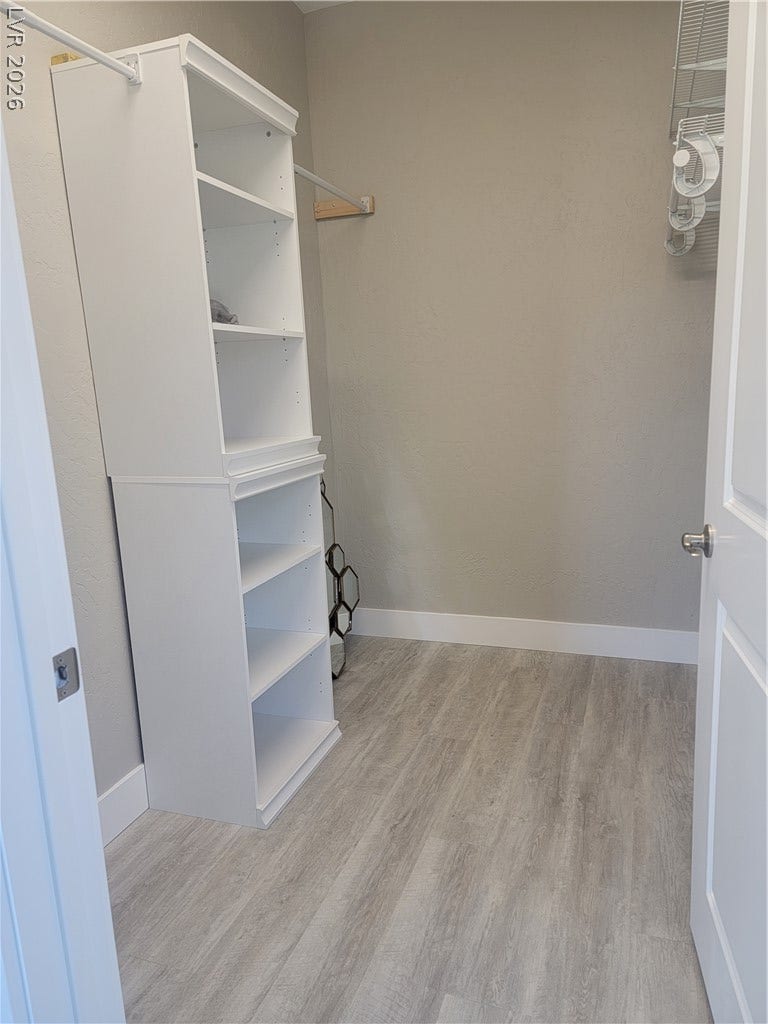 240 San Salvador Avenue, Henderson, NV 89002 A spacious walk-in closet boasts generous built-in storage units and light-toned wood-look flooring.