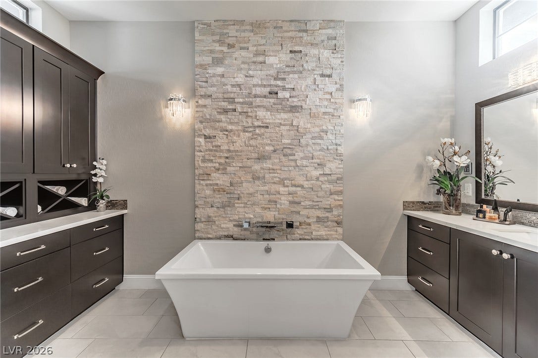 240 San Salvador Avenue, Henderson, NV 89002 A deep soaking tub sits centered against a textured stone accent wall.
