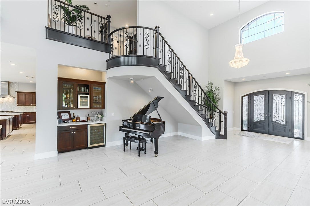 240 San Salvador Avenue, Henderson, NV 89002 An elegant staircase with wrought iron railings highlights this soaring entrance foyer.