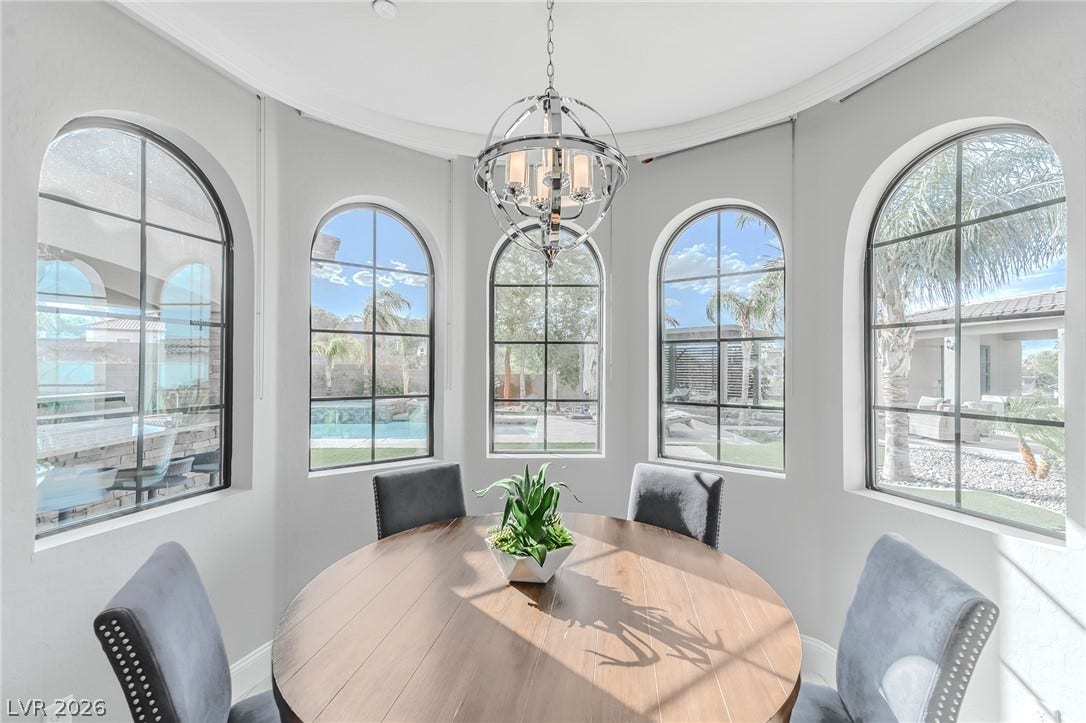 240 San Salvador Avenue, Henderson, NV 89002 Arched windows frame tranquil views of the backyard pool area from this sunlit dining alcove.