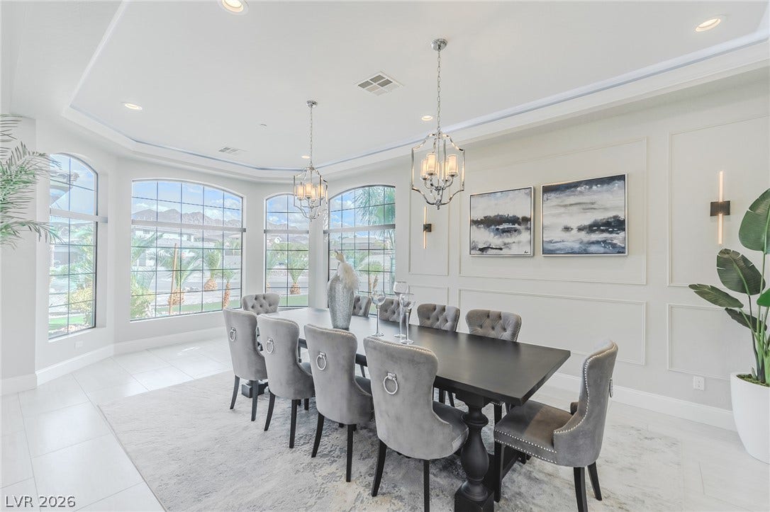 240 San Salvador Avenue, Henderson, NV 89002 Elegant crown molding and recessed lighting frame a spacious formal dining area lined with arched windows.