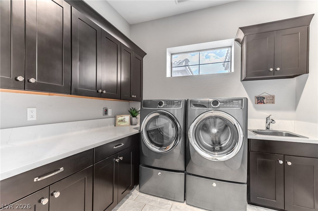 240 San Salvador Avenue, Henderson, NV 89002 Ample cabinetry and stone countertops elevate this functional laundry space.
