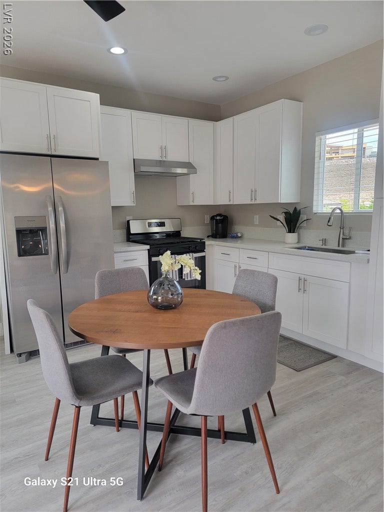 240 San Salvador Avenue, Henderson, NV 89002 An open kitchen arrangement is illuminated by recessed lighting over light plank flooring.