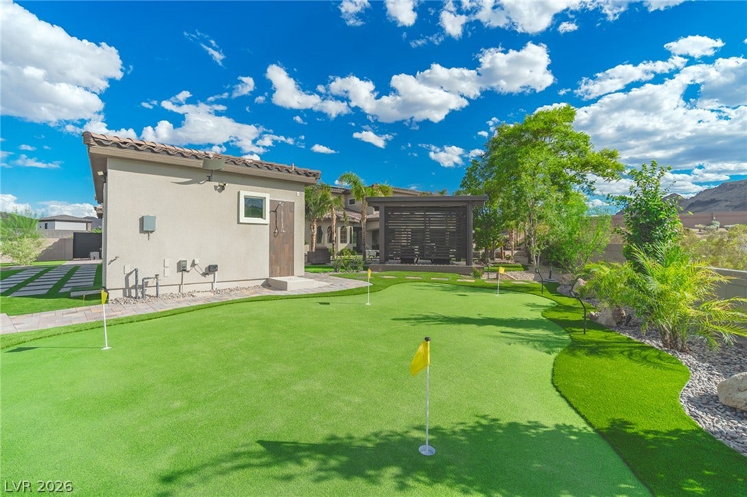 240 San Salvador Avenue, Henderson, NV 89002 An immaculate backyard putting green offers the perfect space for outdoor recreation and leisure.