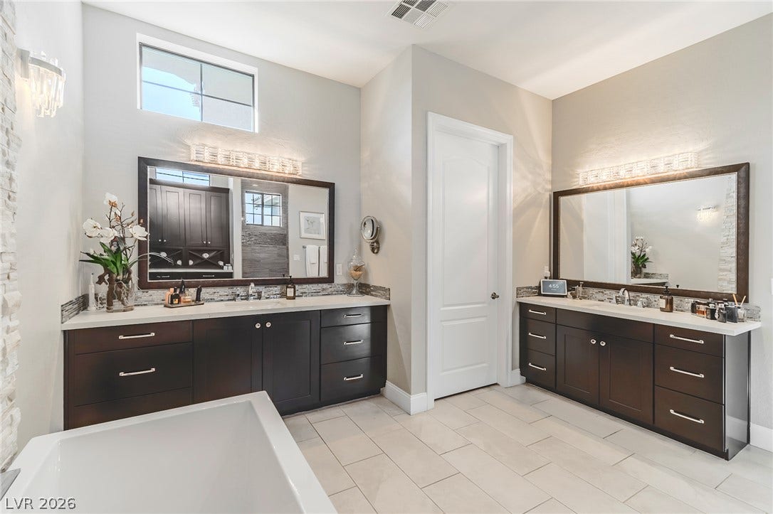 240 San Salvador Avenue, Henderson, NV 89002 Dual vanities with stone counters and a soaking tub anchor this refined, tile-floor space.