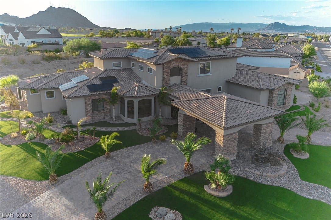 240 San Salvador Avenue, Henderson, NV 89002 A grand porte-cochere and tile roof define the exterior of this desert estate.