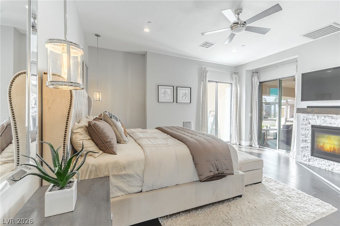 240 San Salvador Avenue, Henderson, NV 89002 Hardwood floors and a modern fireplace elevate this peaceful bedroom retreat.