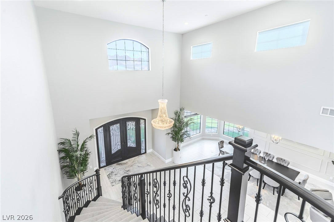 240 San Salvador Avenue, Henderson, NV 89002 Soaring ceilings and an elegant staircase frame this light-filled entry foyer.