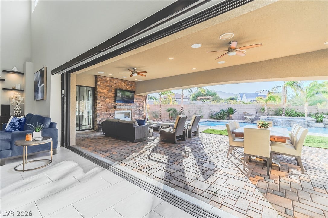 240 San Salvador Avenue, Henderson, NV 89002 Retractable glass doors seamlessly connect the indoor living space to a covered backyard patio.