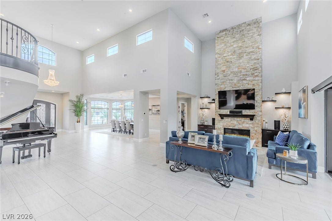 240 San Salvador Avenue, Henderson, NV 89002 Soaring ceilings and a floor-to-ceiling stone fireplace anchor this light-filled great room.