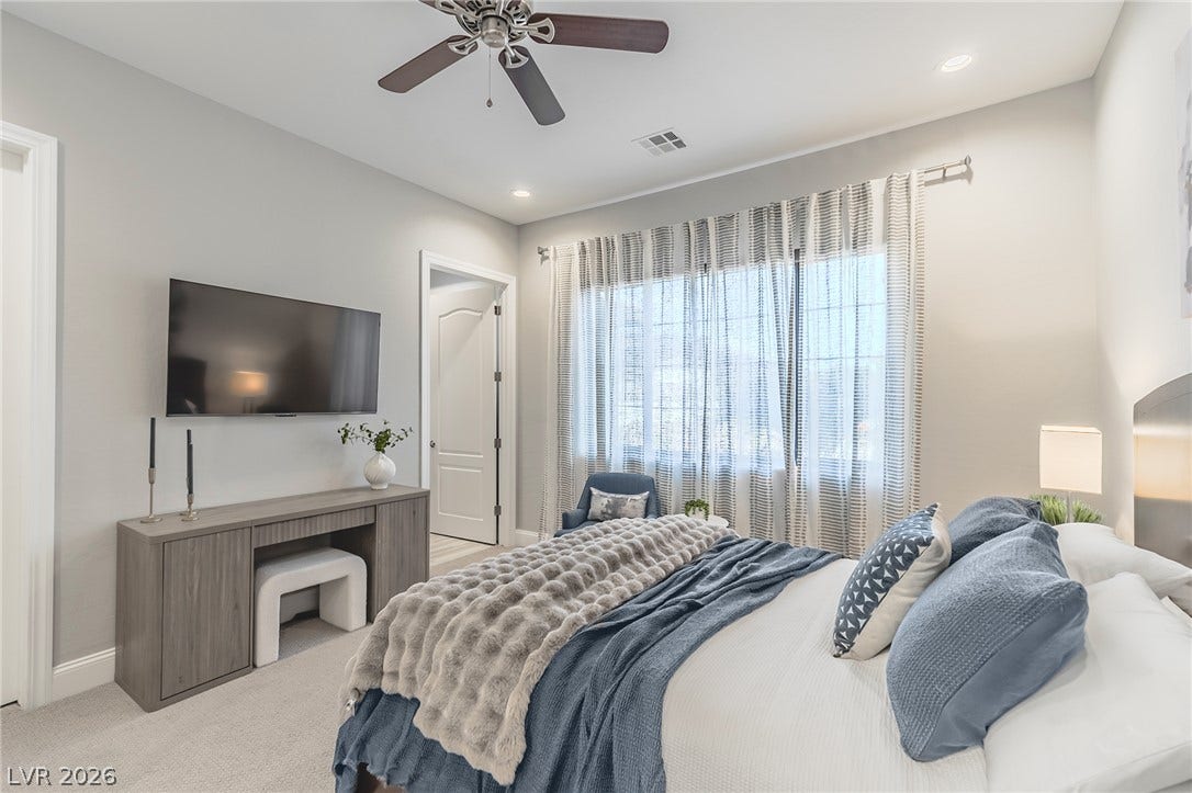 240 San Salvador Avenue, Henderson, NV 89002 Soft carpeting pairs with recessed lighting and a large window in this peaceful bedroom.