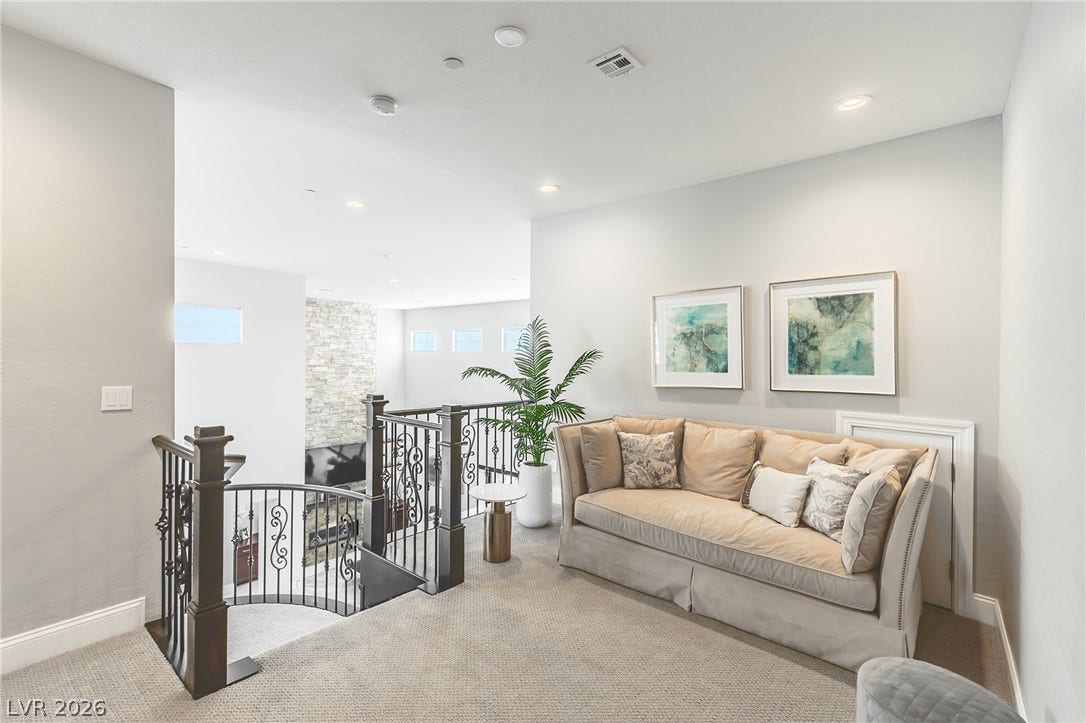 240 San Salvador Avenue, Henderson, NV 89002 An inviting upper-level landing overlooks the lower living space through elegant wrought-iron railings.