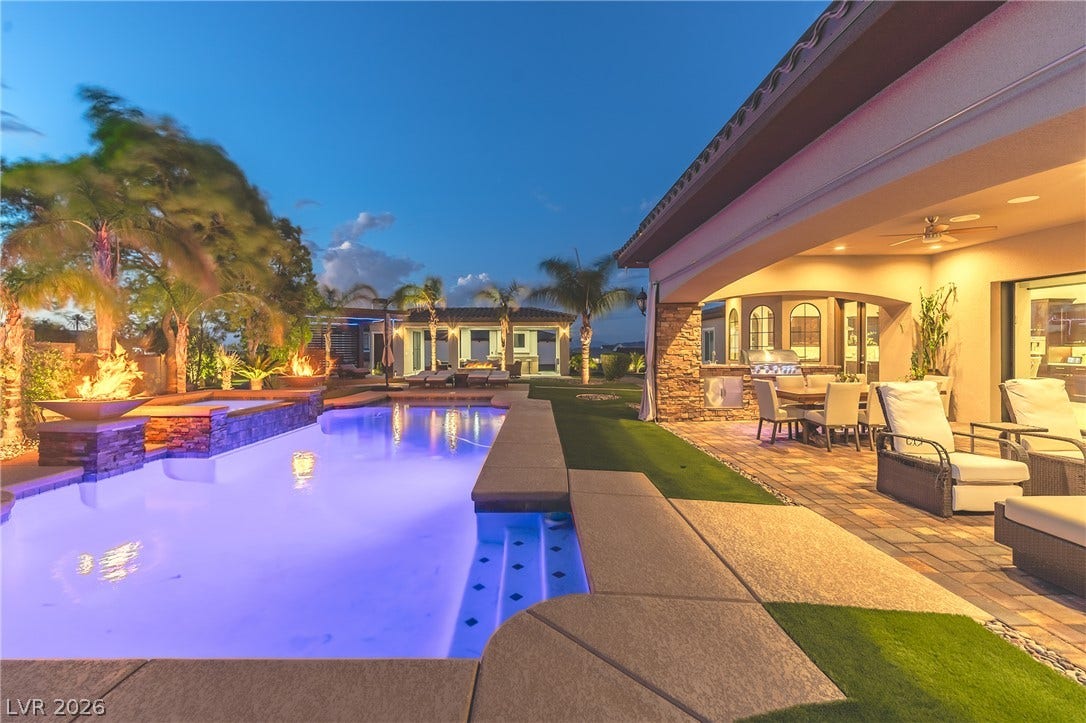 240 San Salvador Avenue, Henderson, NV 89002 An inviting backyard oasis showcases a sparkling pool alongside stone-paved patios and built-in amenities.