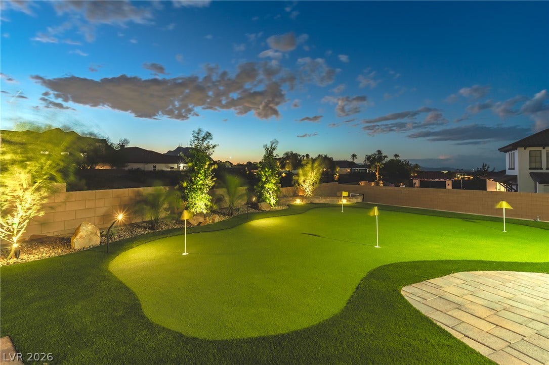 240 San Salvador Avenue, Henderson, NV 89002 A private backyard putting green offers endless outdoor entertainment under the twilight sky.
