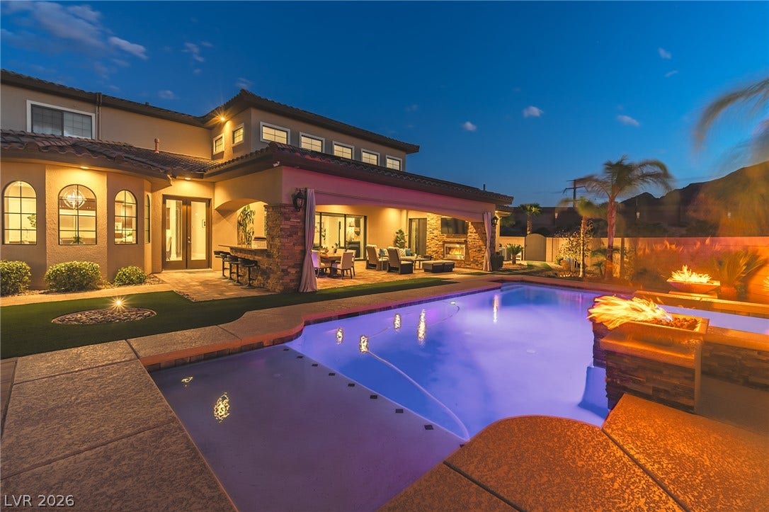 240 San Salvador Avenue, Henderson, NV 89002 An inviting backyard oasis features a heated pool alongside custom stone masonry.