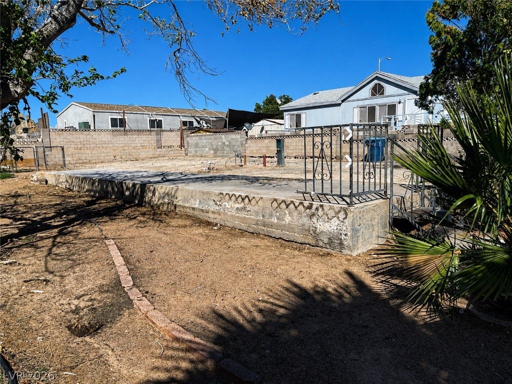 6196 Castlemont Avenue, Las Vegas, NV 89156 A spacious concrete pad provides a solid foundation for outdoor projects under open blue skies.