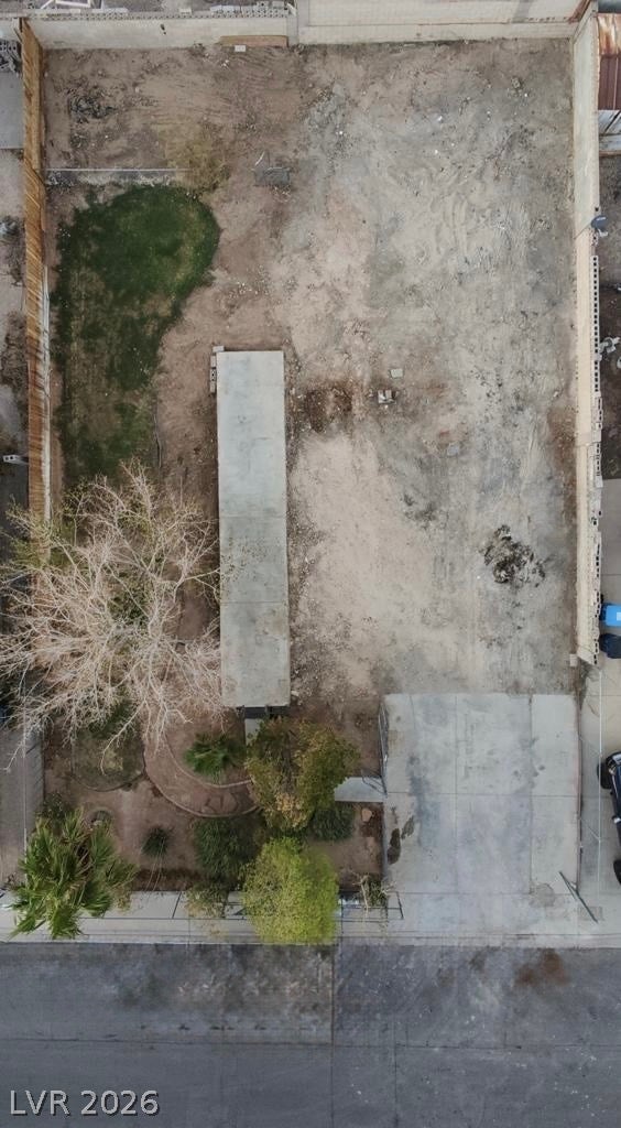 6196 Castlemont Avenue, Las Vegas, NV 89156 An aerial perspective reveals a level lot with a concrete pad and secure perimeter fencing.