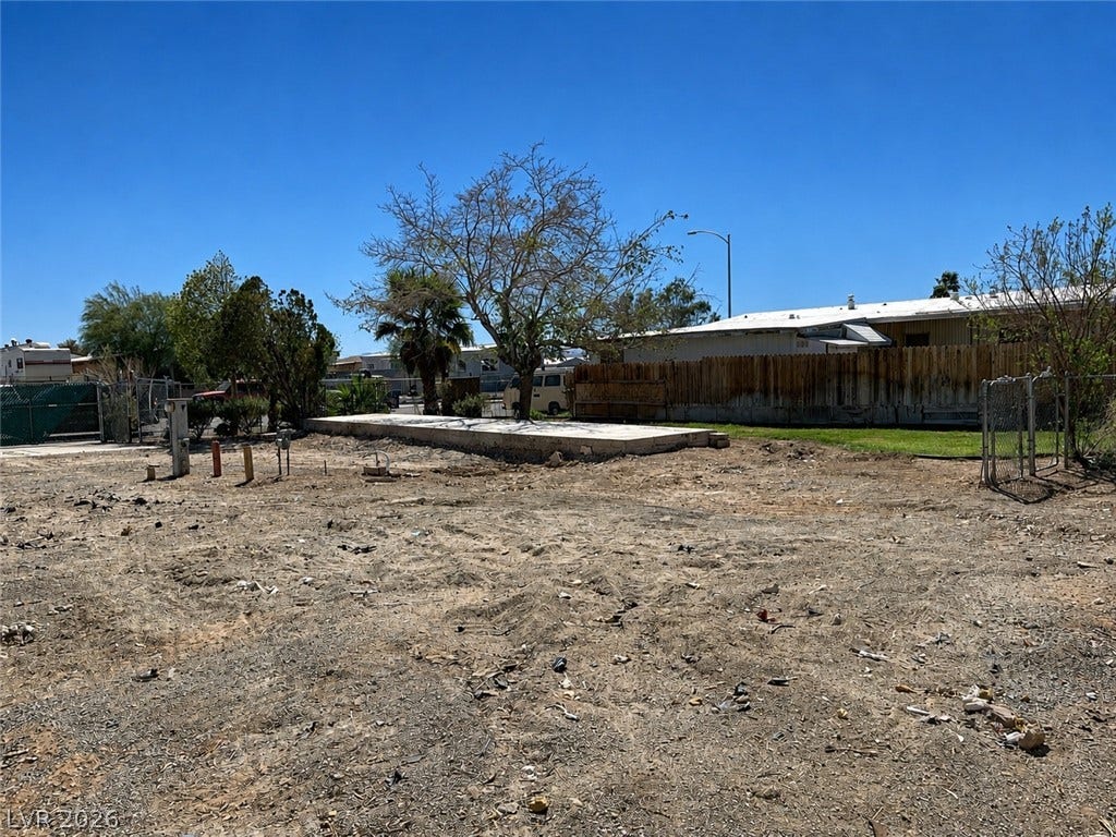 6196 Castlemont Avenue, Las Vegas, NV 89156 An open dirt lot features a raised concrete slab foundation under a clear blue sky.