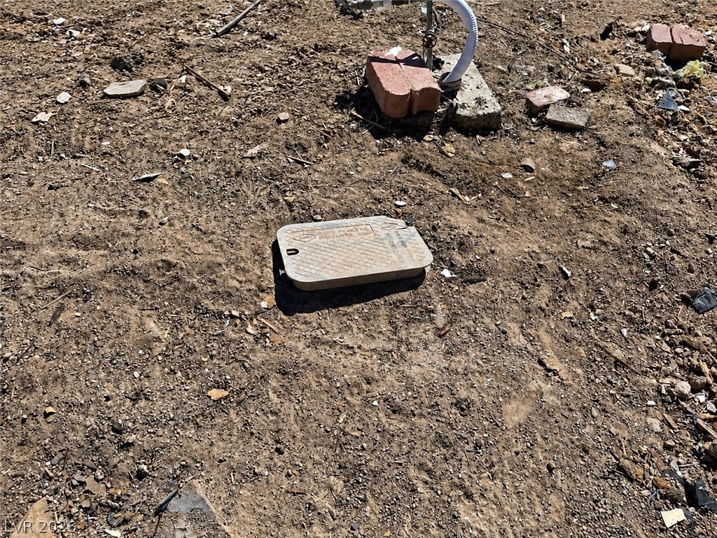 6196 Castlemont Avenue, Las Vegas, NV 89156 In-ground utility connections and irrigation equipment sit installed within the soil on the lot.