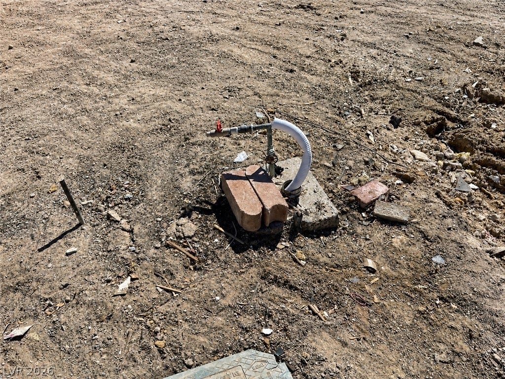 6196 Castlemont Avenue, Las Vegas, NV 89156 A functional outdoor utility hookup stands ready on the open dirt ground.