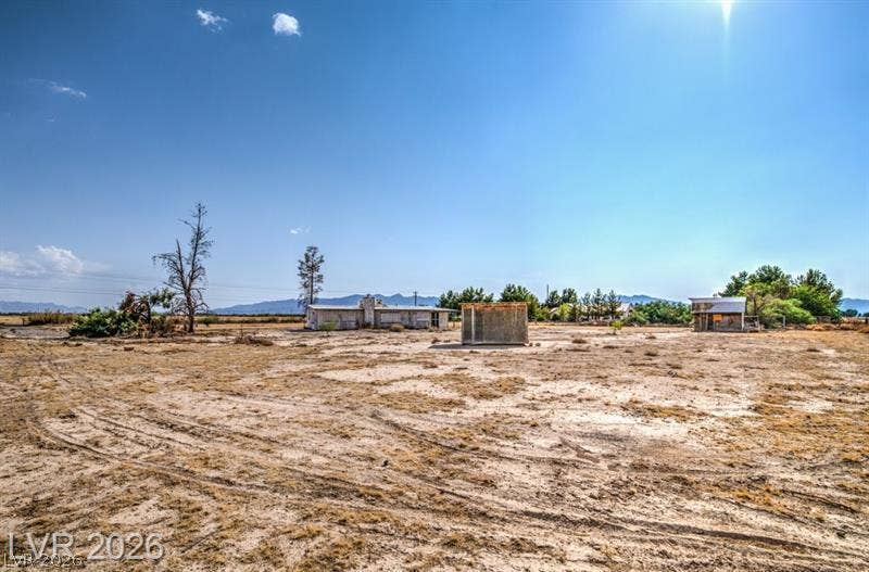 000 Linda Leslie Manse Street, Pahrump, NV 89060 A vast desert acreage contains multiple outbuildings under wide open blue skies.