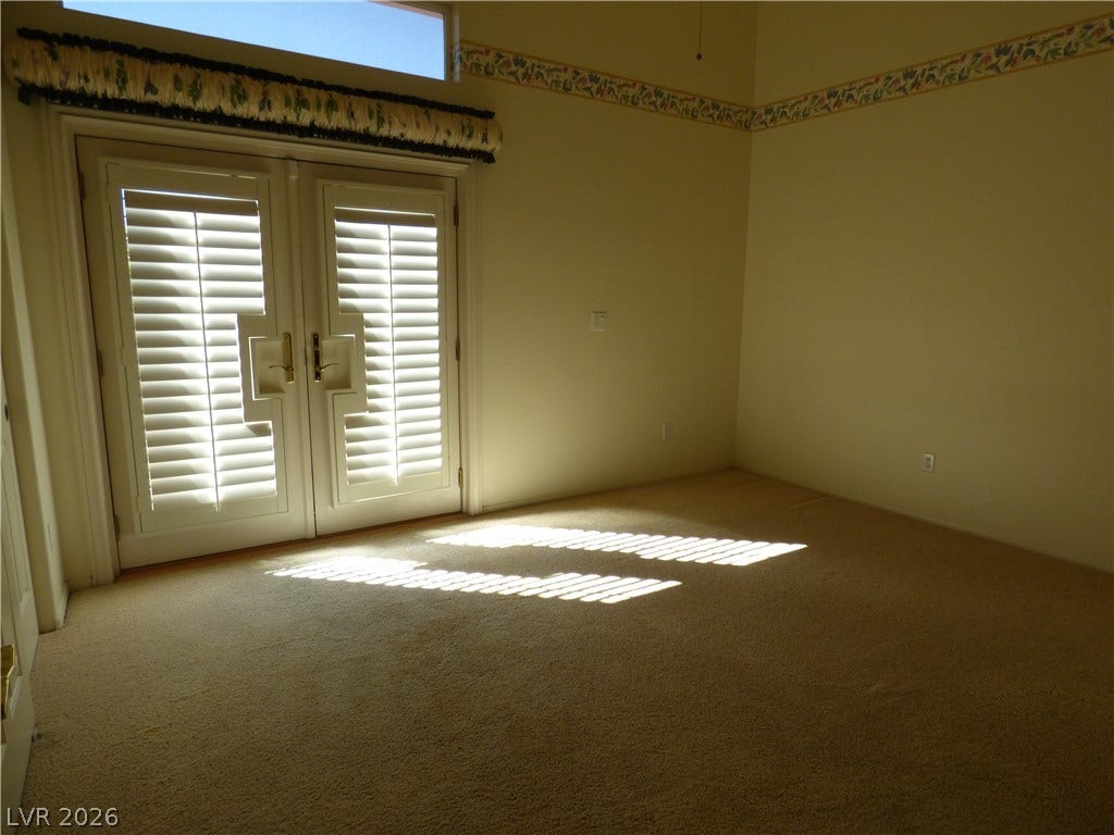 7695 Gilespie Street, Las Vegas, NV 89123 Double doors with integrated shutters open to the outdoors from this bedroom that shares a Jack & Jill bath.