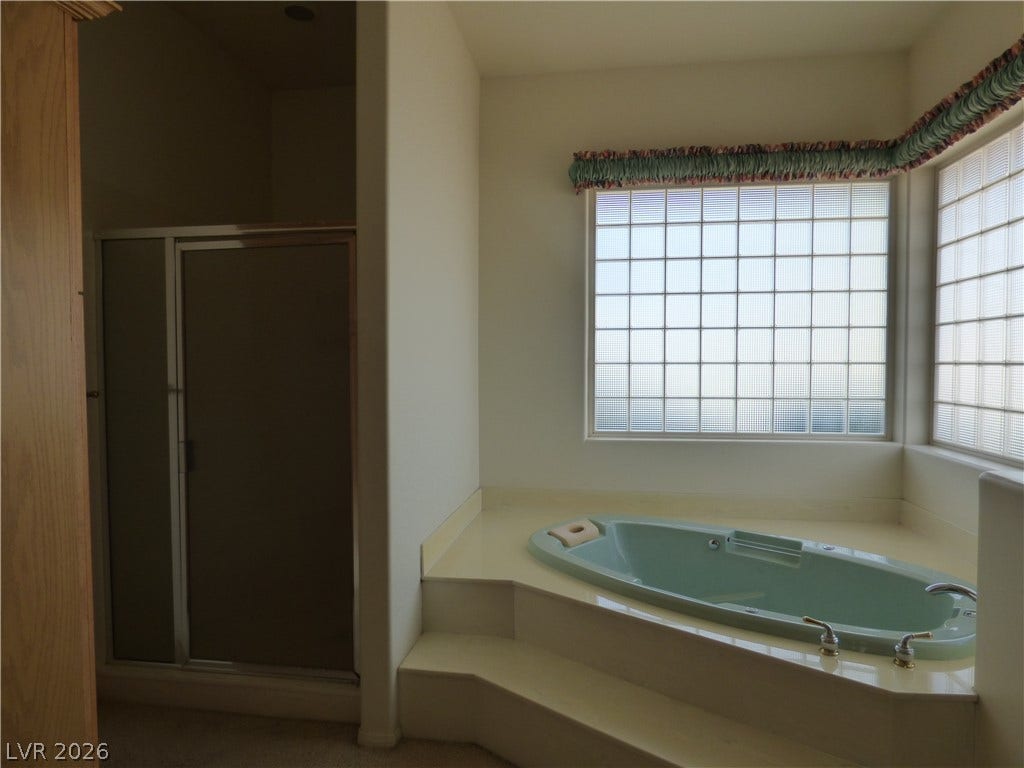 7695 Gilespie Street, Las Vegas, NV 89123 Glass block windows fill this bathroom with soft natural light.