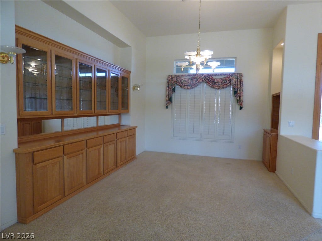 7695 Gilespie Street, Las Vegas, NV 89123 A spacious formal dining room features extensive built-in cabinetry and towering ceilings.