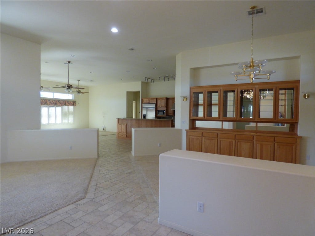 7695 Gilespie Street, Las Vegas, NV 89123 An open floorplan connects the living spaces, highlighted by tile flooring and a built-in hutches.